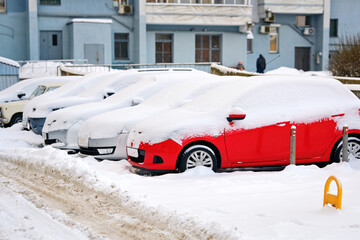 Cars parked on parking lot in cold winter season. Cars parked on snowy parking in residential area. Parking problems not enough free space..