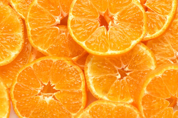 juicy and appetizing tangerines cut into circles as a food background 3