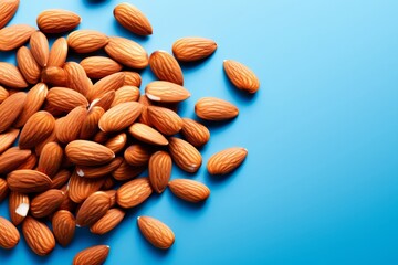 Fresh Almonds on Vibrant Blue Background - Health Concept
