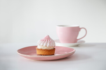 cupcake with cup of coffee on white table