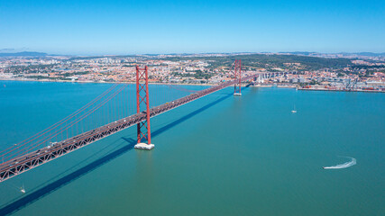Aerial photo from drone to The 25 de Abril Suspension Bridge over Tagus river in Lisbon, the...