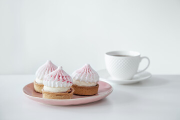 cupcakes with cup of coffee on white table