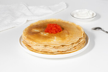 Pancakes with red caviar,Close-up of pancakes stacked on white background