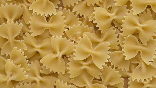 Italian farfalle pasta background. Seamless loop. 