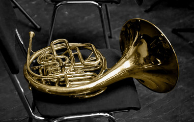  brass musical instrument horn lying on a chair
