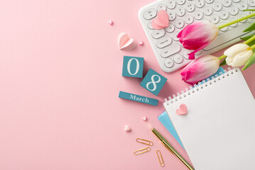 Celebrate the businesswoman in your life with this Woman's Day greeting! Top view of a keyboard, vibrant tulips, hearts, diaries, stationery, and a calendar set to March 8 on a pastel pink backdrop
