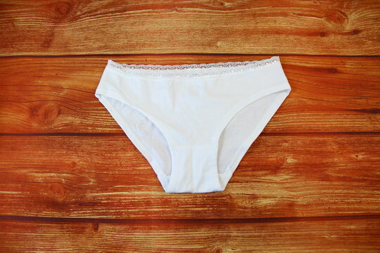 Cotton white panties on wooden background with a copy space