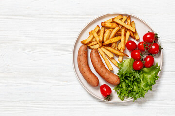 sausages with potato, lettuce, tomatoes, top view