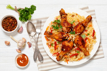 fried chicken drumsticks over rice pilaf, top view