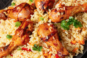 fried chicken drumsticks over rice pilaf, top view