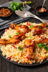 fried chicken drumsticks over rice pilaf, top view