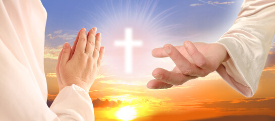 biblical scene, close-up of Jesus Christ Hand against sunset in evening beautiful dramatic sky ask...