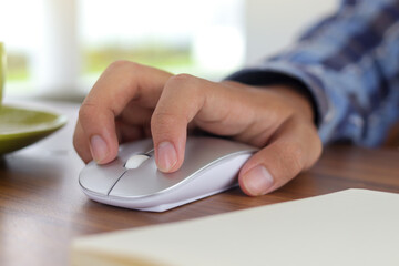 Close up of male hand using wireless keyboard and mouse in office desk. Casual working concept