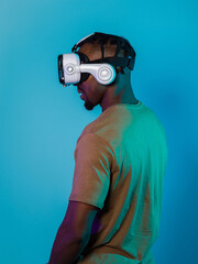 In a futuristic visual, an African American man stands isolated against a striking blue backdrop,...