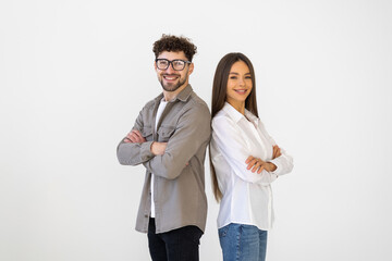 Young Couple in business suits standing back to back with crossed arms on white background