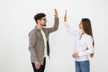 Enthusiastic business partners giving each other a high five on white background
