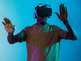 Immersed in a digital realm, an African American man navigates the virtual landscape with a VR...