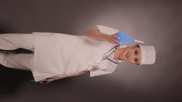 Emotional young woman doctor nurse in a white coat and hat