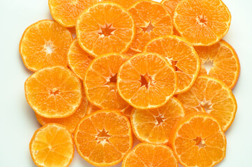 juicy and appetizing tangerines cut into circles as a food background 1