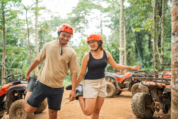 happy asian couple warming up together before enjoy the atv track