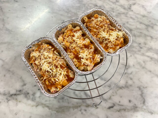 Baking macaroni scotel with mozarella