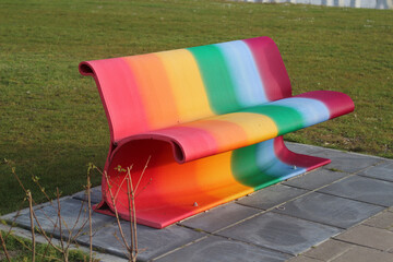 Colorful rainbow painted bench in spring. Supporting of LGBTQ
