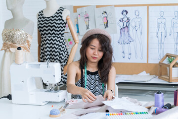 Young woman owns fashion garment. Women fashion designer stylist working.