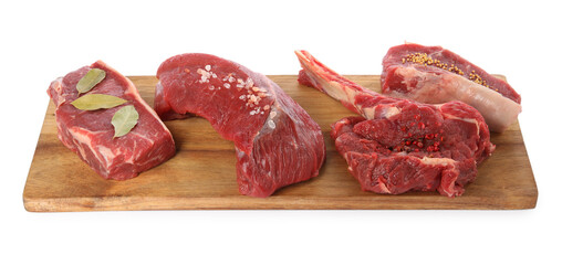 Board with pieces of raw beef meat and spices isolated on white