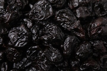 Sweet dried prunes as background, closeup view
