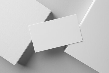 Empty business card and decorative elements on white background, top view. Mockup for design