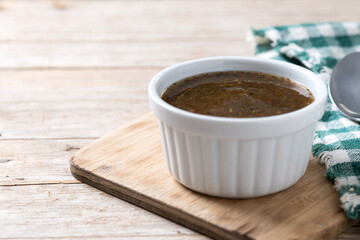 Green Chimichurri Sauce on wooden table. Copy space