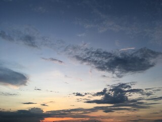 A dramatic sky filled with majestic, rolling clouds creates a breathtaking view. The shifting patterns and vibrant hues capture nature's dynamic beauty.