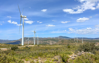 Wind turbine in mountains landscape. Eolic park windpower. Wind farm, New Wind green energy. Wind turbines alternative energy. Windmill power clean electricity generation. Spain Windfarm in Castellon