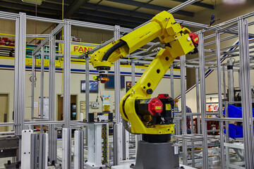 Yellow Robotic Arm in High-Tech Factory Setting