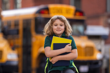 Child with backpack and book getting on the school bus. American School. Back to school. Kid of primary school. Happy children ready to study. Student ready to study.