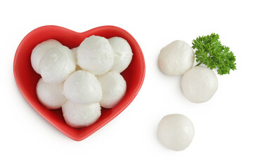 Mini mozzarella balls with parsley in a red ceramic bowl isolated on white background. Top view. Flat lay.