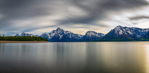 Panorama of Jackson Lake with Grand Teton Mountains in the background in Wyoming, USA. Long...