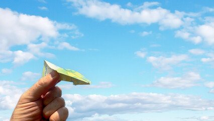 Euro note as paper airplane. 100 euros Banknote in form of paper plane. Money of European Union...