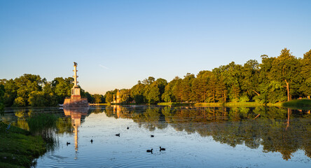 Evening landscape on the lake in Catherine Park with the Chesme Column and the Admiralty. Reflection in water.