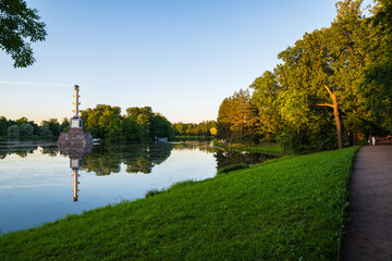 Fototapeta premium Evening landscape on the lake in Catherine Park with the Chesme Column. Reflection in water.