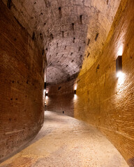 Curved Brick Corridor with Arched Ceiling and Dim Lighting