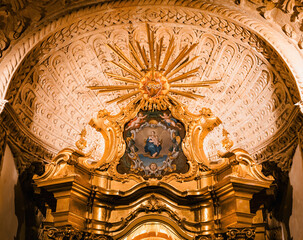 A captivating low-angle view of the altar at the Catedral-Basilica de Santa Maria de Mallorca, featuring an exquisite depiction of Saint Mary holding Baby Jesus