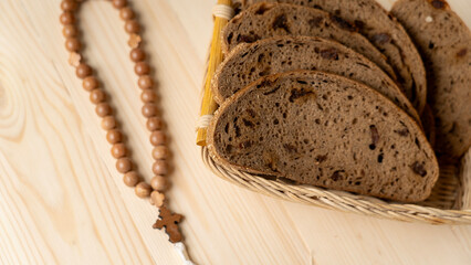 Bread and rosary on wooden table. Lenten food during the Great Orthodox Lent