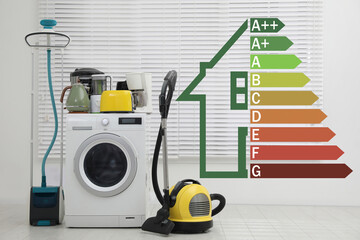 Energy efficiency rating label and different household appliances near window indoors