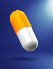 Colorful vitamin capsule in air on blue gradient background