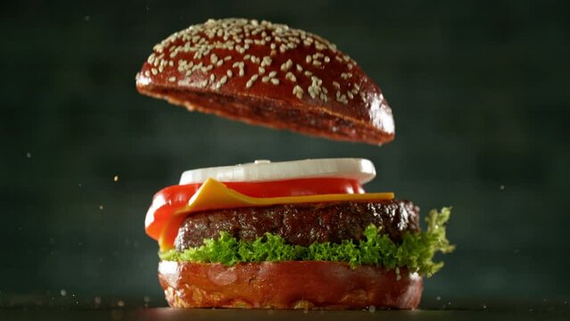 Super slow motion of stacking hamburger pieces. Camera in motion. Filmed on high speed cinema camera, 1000 fps. Placed on high speed cine bot. 