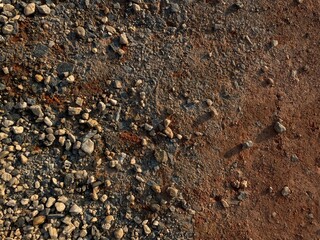 texture background with stones  on the red soil