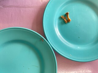 An orange ant is walking on a plate of food.