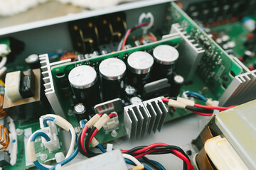 An up-close view of a circuit board showing the intricate network of wires and connections of an amplifier