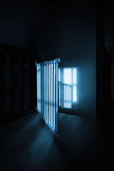 A close-up of a wooden stair barrier in a luxury house, bathed in sunrays. The dark corridor glows with warmth, creating a stunning visual contrast